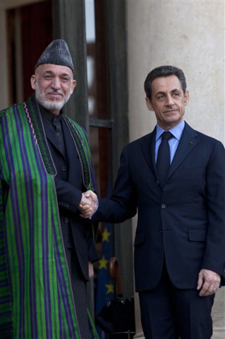 French President Nicolas Sarkozy, right, welcomes Afghan President Hamid Karzai at the Elysee Palace in Paris on Friday.